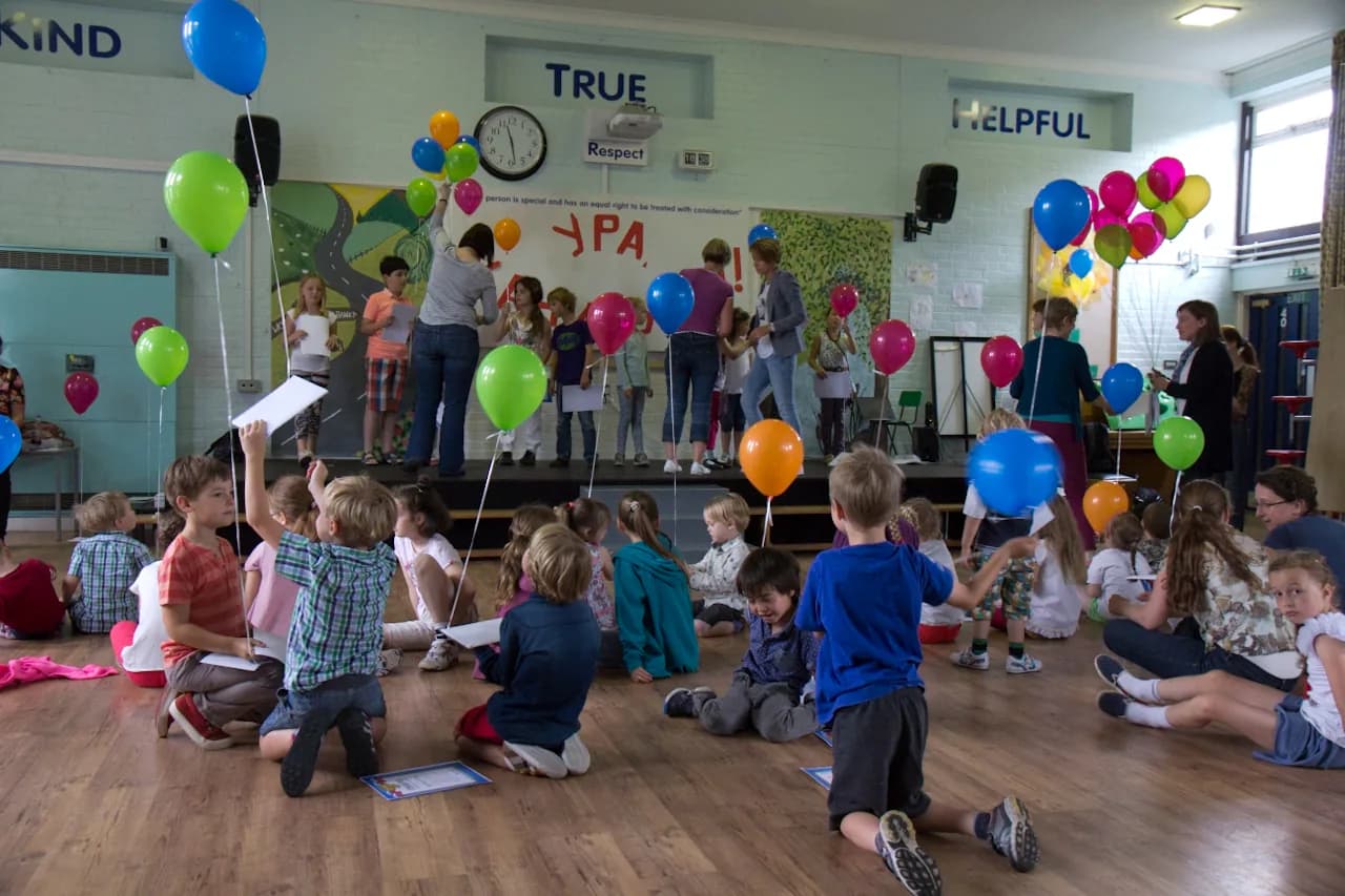 Children and families gathered with balloons during a school event.