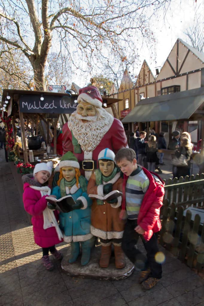 Children visiting a seasonal winter market display.