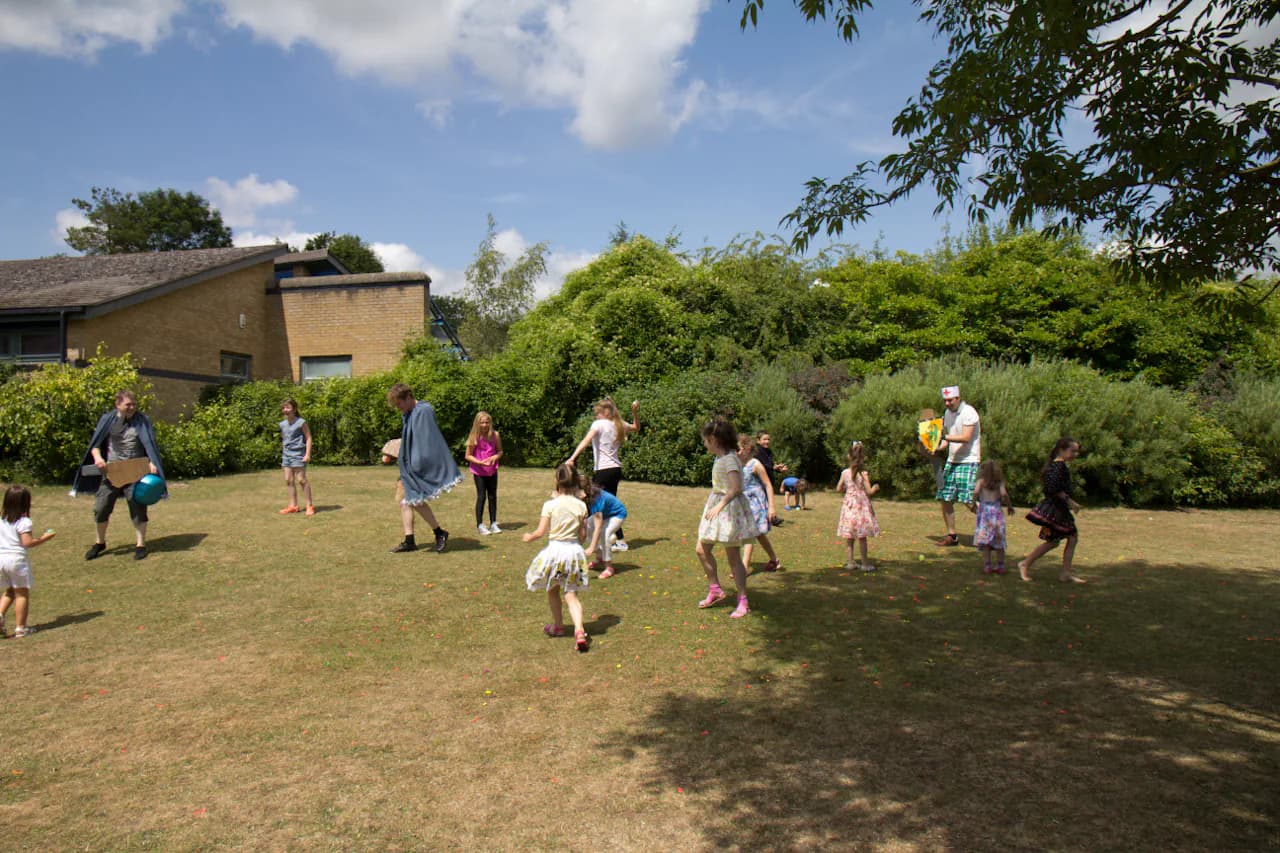 Children playing an outdoor school game on a sunny day.