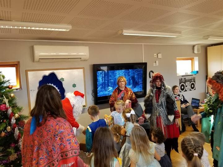 Children watching a classroom presentation during a school celebration.