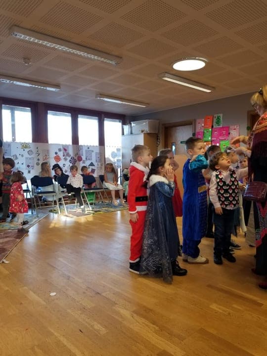 Children and families gathered around a Christmas classroom visit.