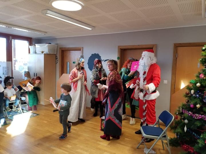A festive classroom visit with children and seasonal characters.