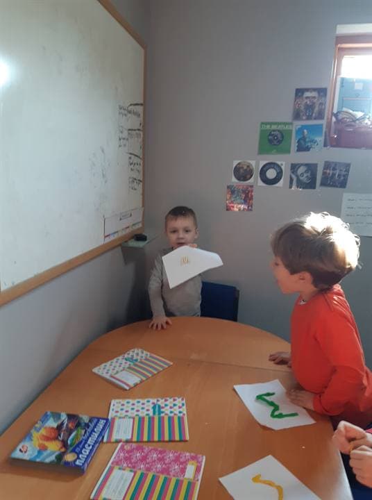 Children working at a small classroom table.