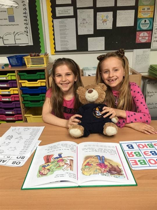 Children sitting with Russian learning materials and workbooks.