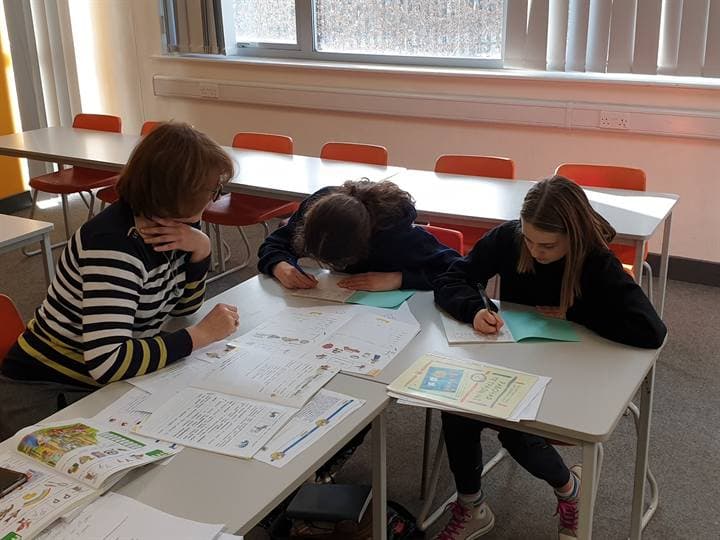 Children working together at a classroom table.