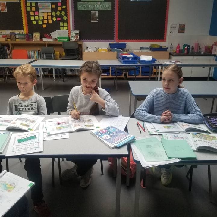 Classroom learning materials arranged on a table.