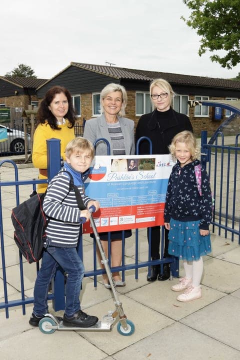 Families and staff gathered outside a school venue.