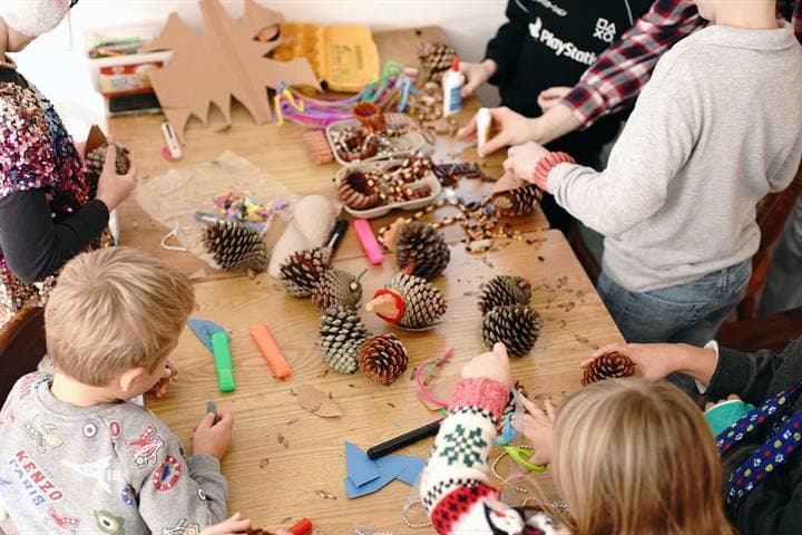 Children working with natural materials during a classroom craft activity.