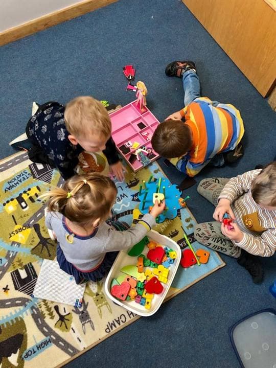 Children working together on a classroom craft activity.