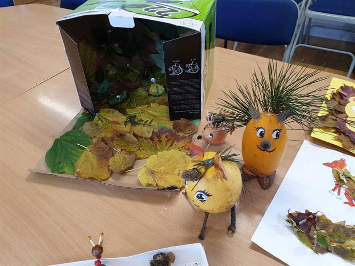 Autumn craft materials displayed on a classroom table.