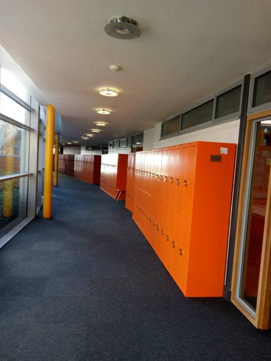 Orange lockers and a corridor in a Southend school venue.