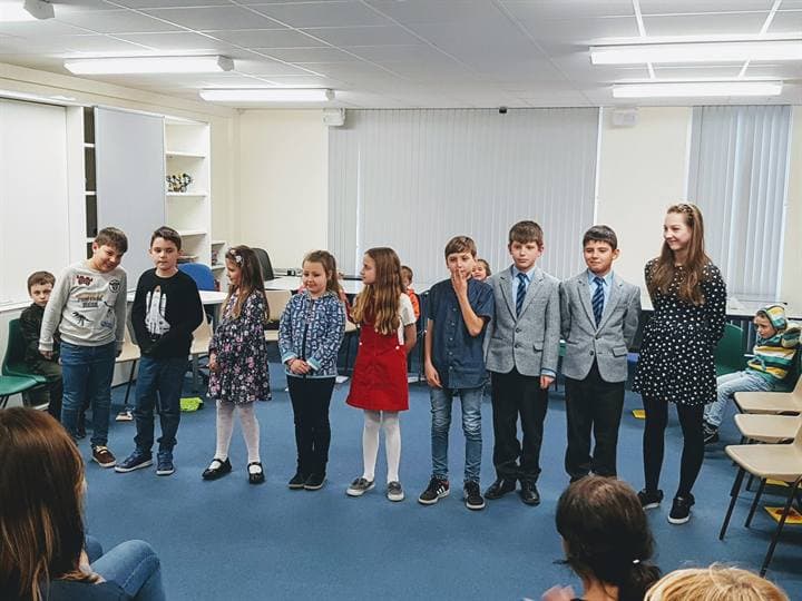 Children standing together during a school performance.