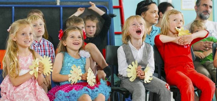 Children watching and reacting during a performance.