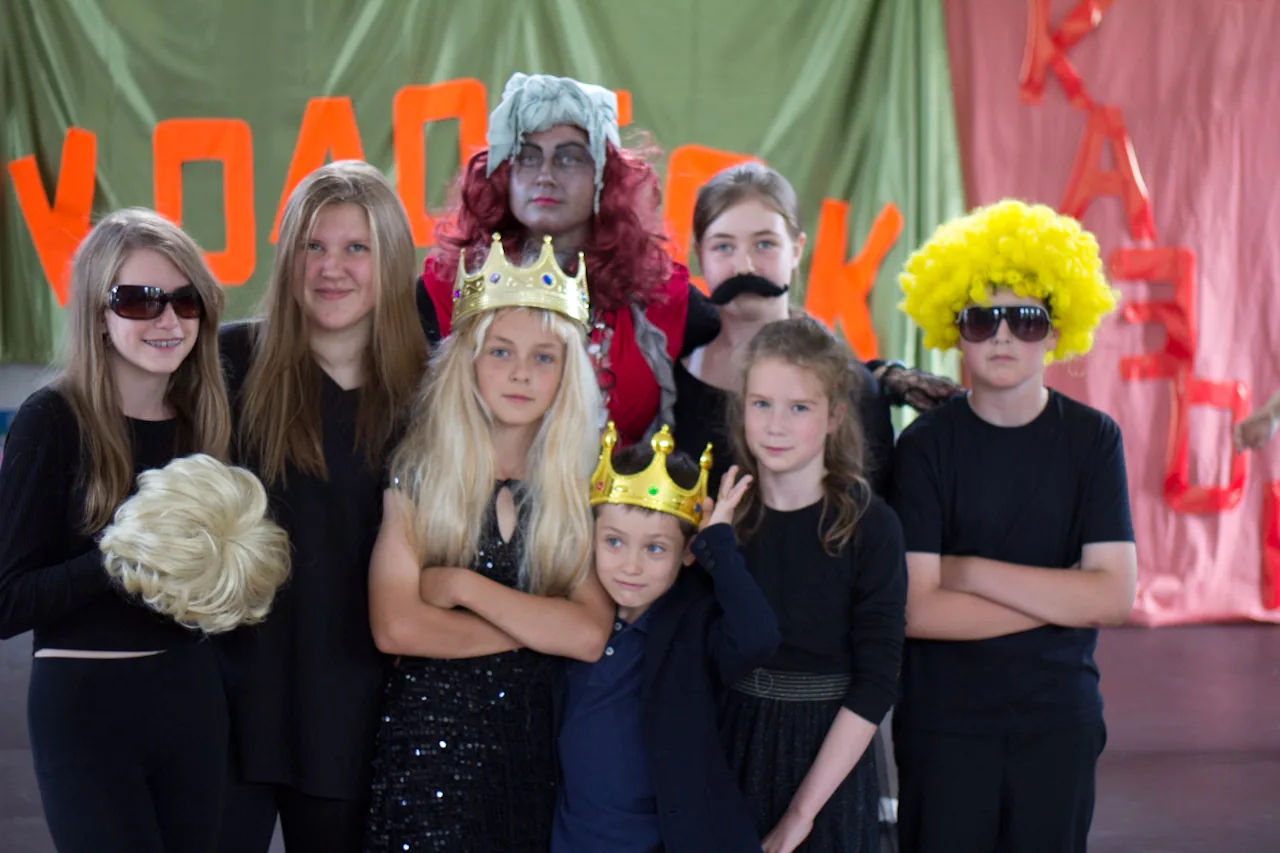 Children in costume posing after a school performance.