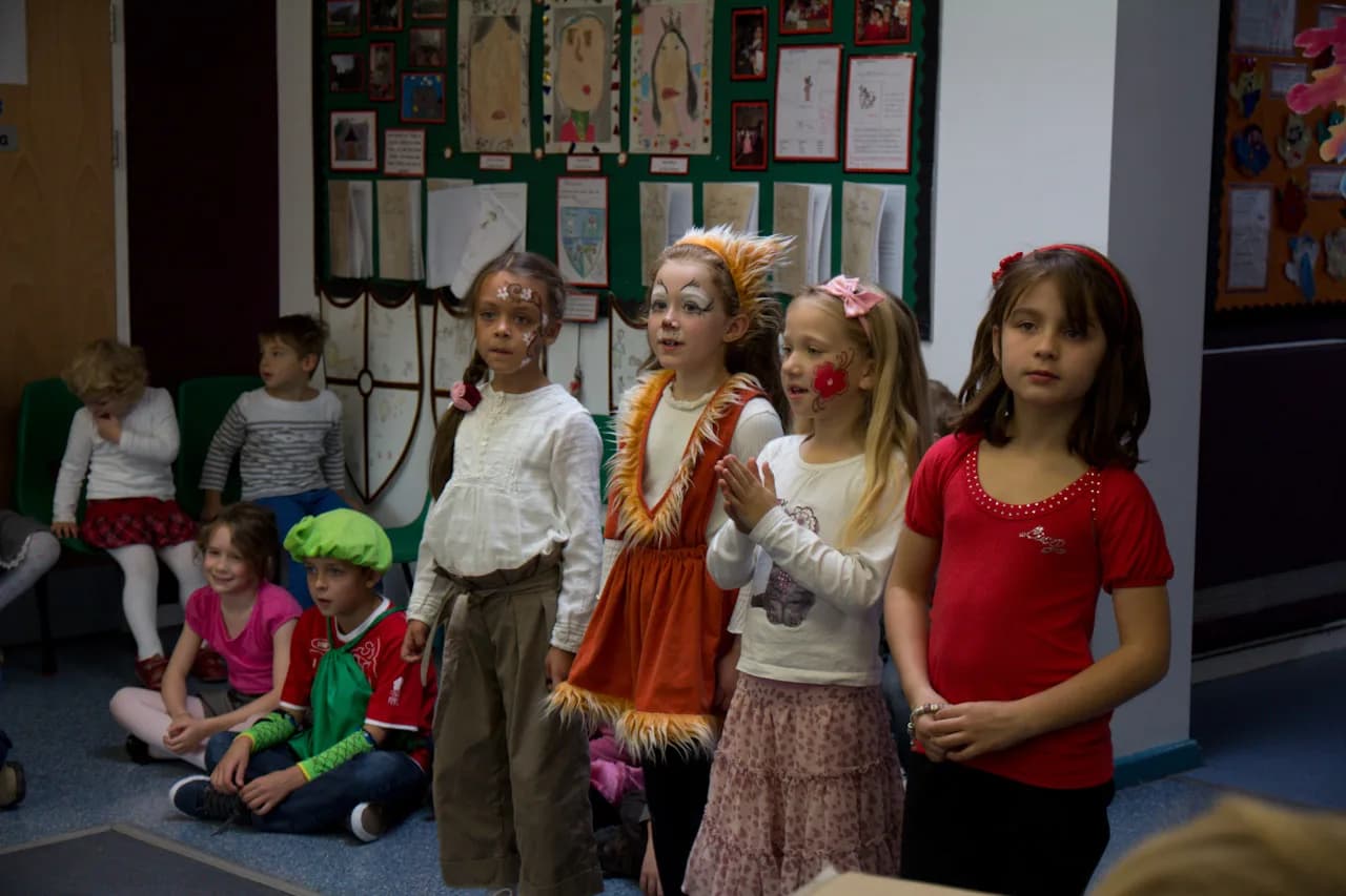 Children in costume standing together during a classroom recital.