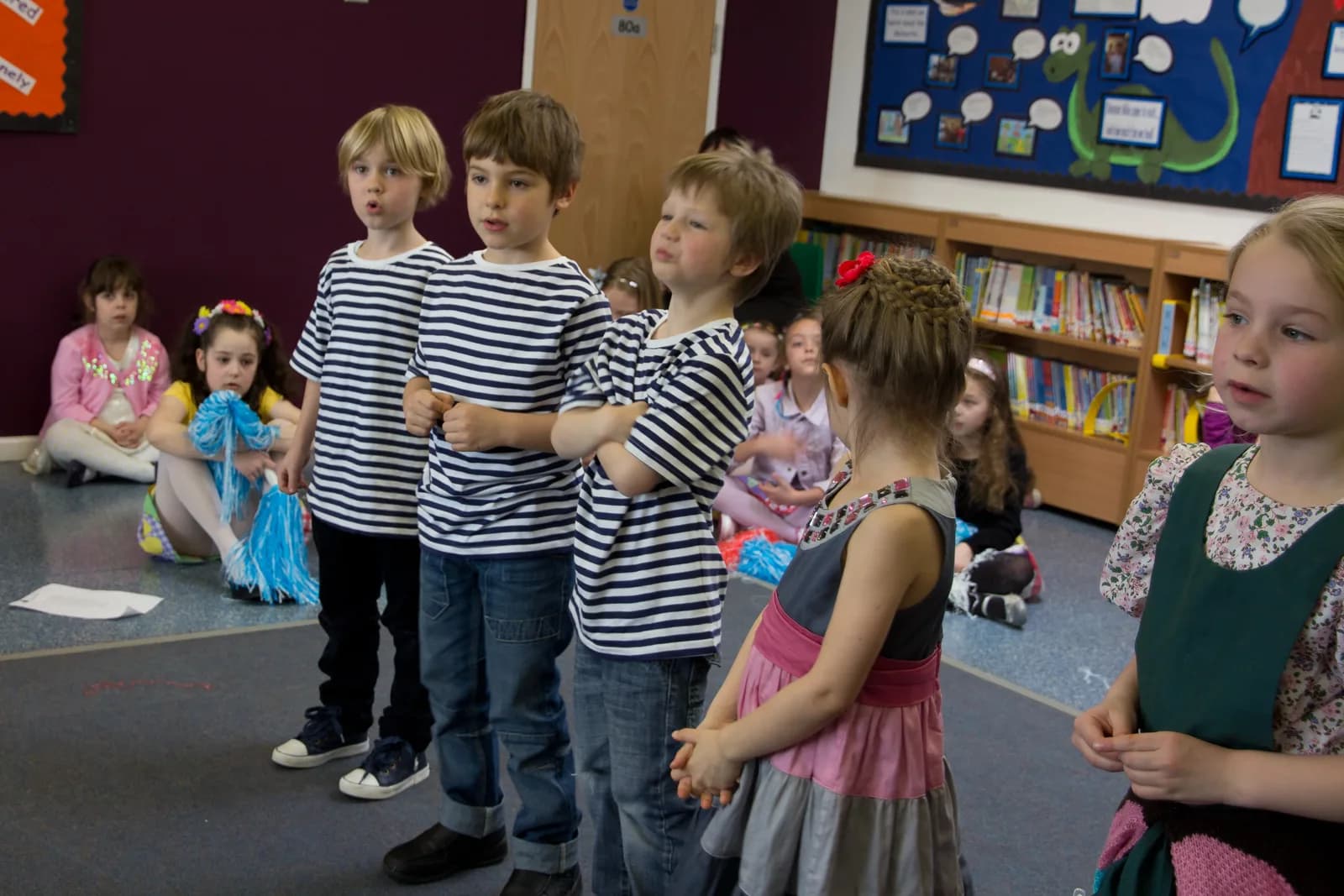 Children standing together during a recital activity.