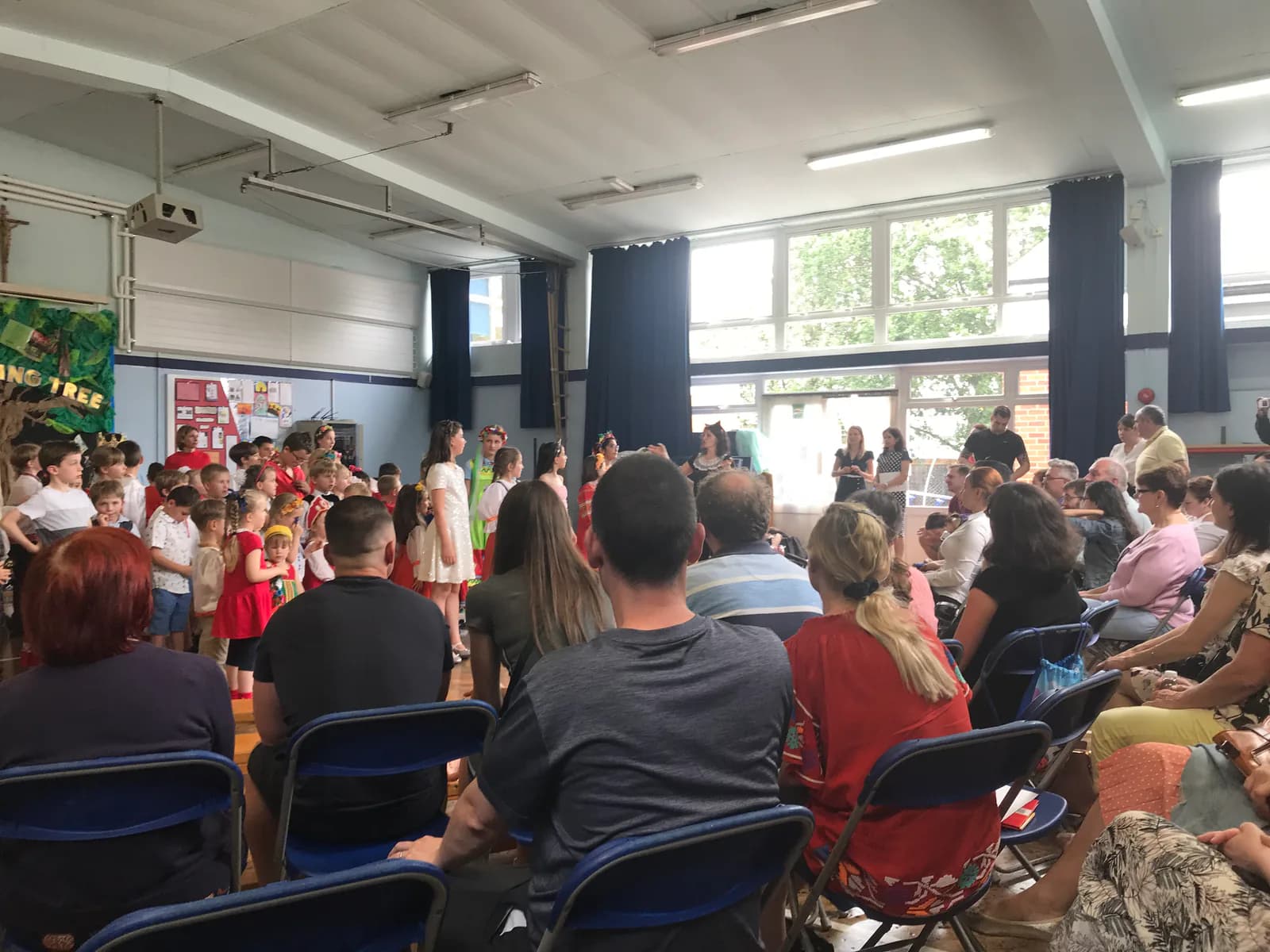 Children performing in front of families at a school event.
