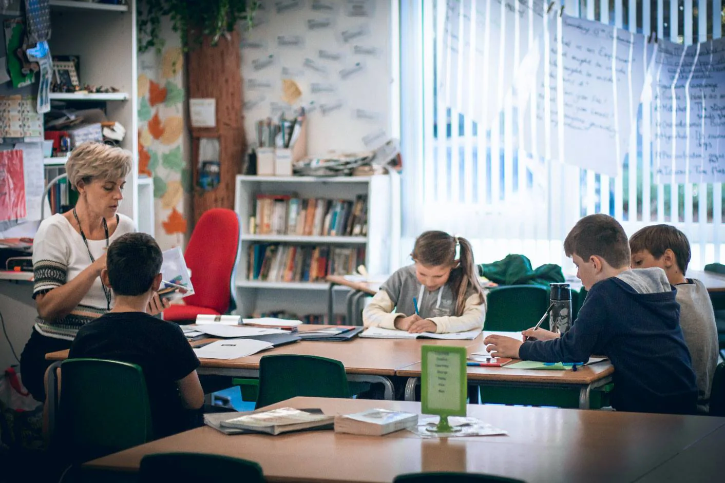 Children working at tables during a Russian school lesson.