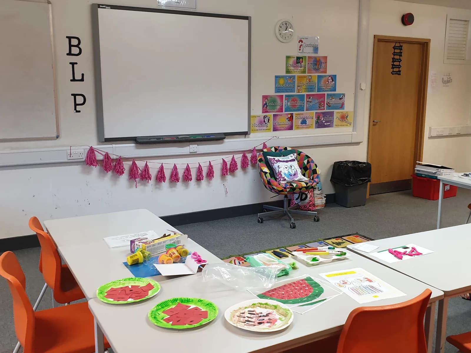 Classroom tables and a whiteboard set up for Russian school.